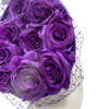 Cadbury purple coloured percher hat with purple roses in the centre and finished with a purple netting over the headpiece.